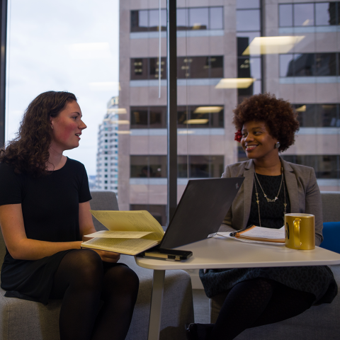 student working with mentor at a table